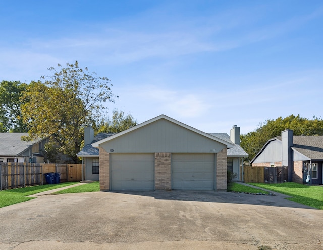 ranch-style home with a front lawn and a garage