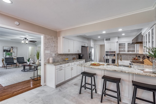 kitchen featuring white cabinetry, light hardwood / wood-style flooring, and stainless steel appliances