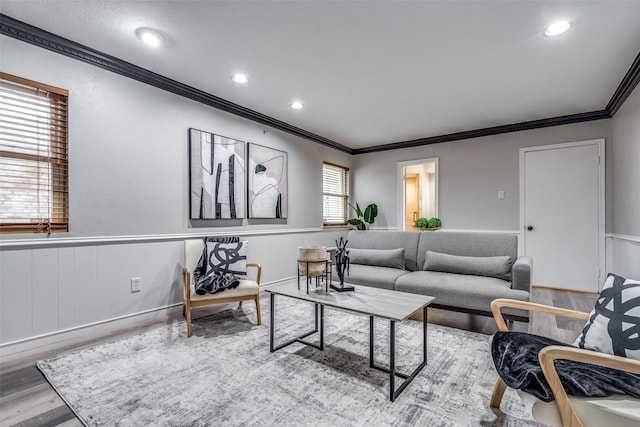 living room with light wood-type flooring and ornamental molding