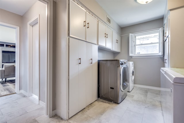 washroom featuring cabinets and washing machine and clothes dryer