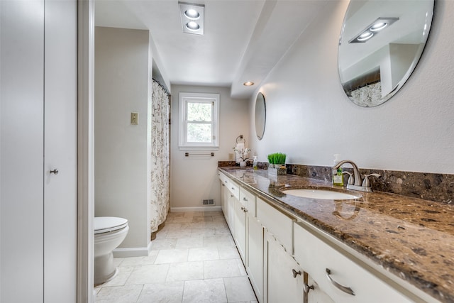 bathroom with tile patterned floors, vanity, and toilet