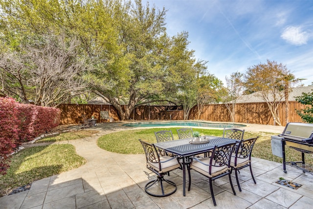 view of patio / terrace featuring a grill and a fenced in pool