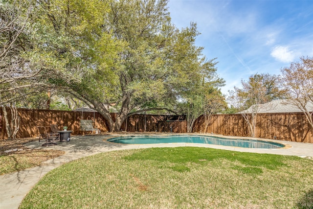 view of pool featuring a lawn and a patio area