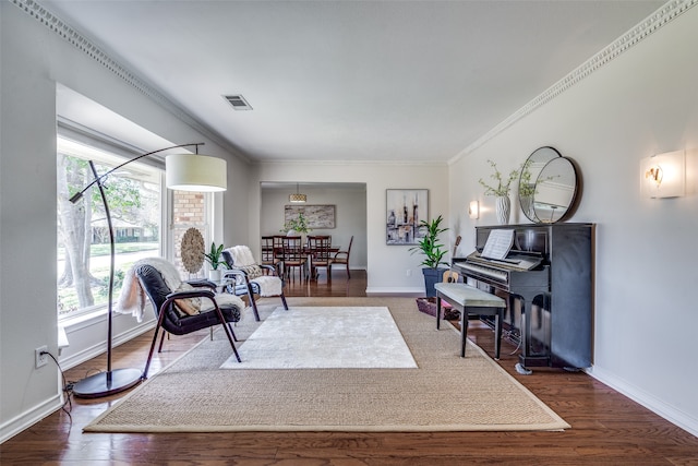 sitting room featuring ornamental molding and dark hardwood / wood-style floors