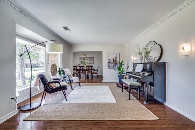 sitting room featuring ornamental molding and dark hardwood / wood-style floors