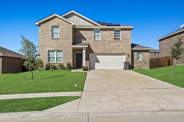 view of front of home with a front lawn, solar panels, and a garage