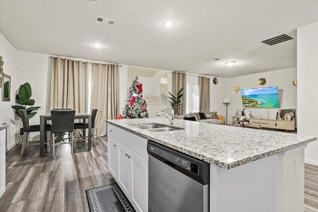 kitchen featuring dishwasher, sink, an island with sink, white cabinets, and hardwood / wood-style flooring