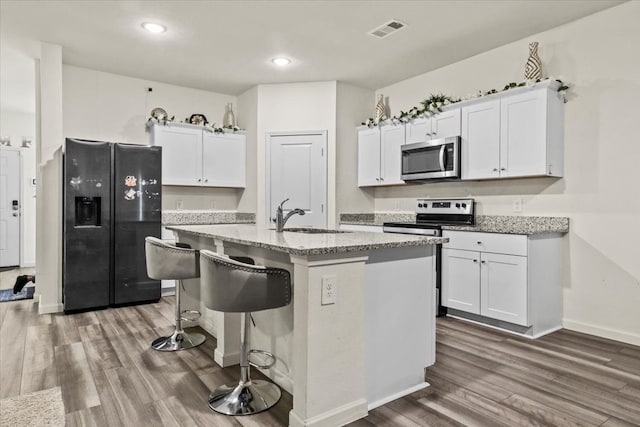 kitchen featuring white cabinetry, sink, dark hardwood / wood-style floors, and appliances with stainless steel finishes