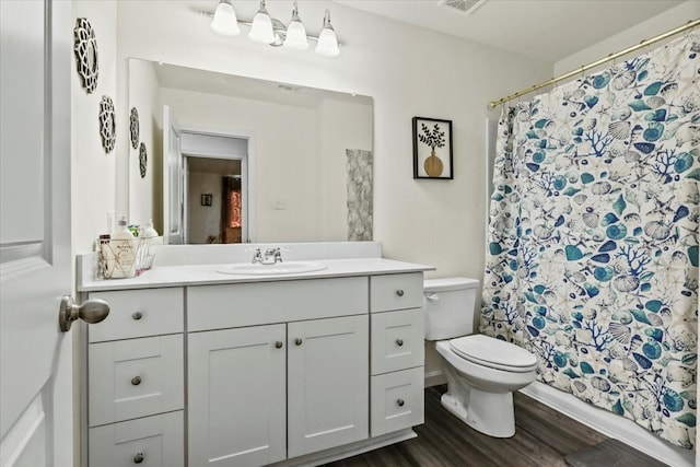 bathroom featuring vanity, hardwood / wood-style flooring, and toilet