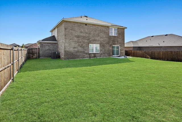 rear view of house featuring a yard