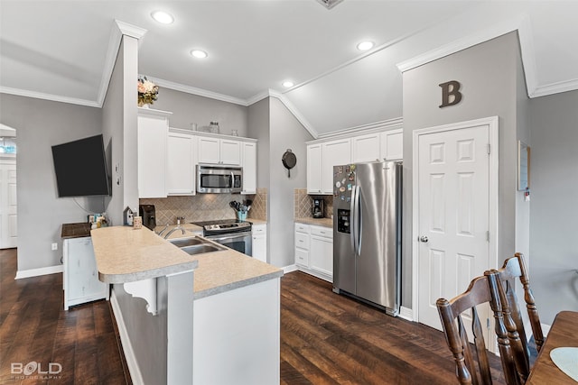 kitchen featuring white cabinetry, dark hardwood / wood-style floors, kitchen peninsula, a breakfast bar area, and appliances with stainless steel finishes