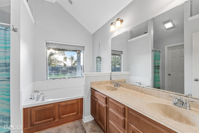 bathroom with vanity, lofted ceiling, and independent shower and bath