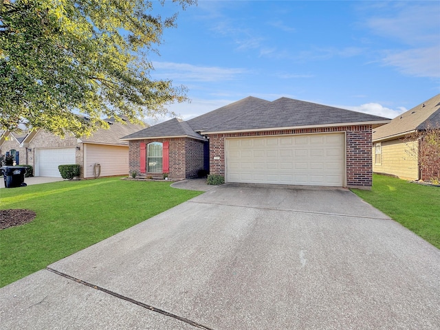 ranch-style home with a garage and a front lawn