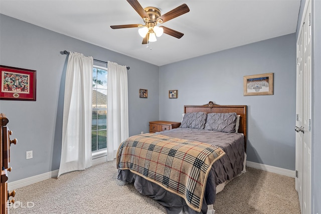 carpeted bedroom with ceiling fan and a closet