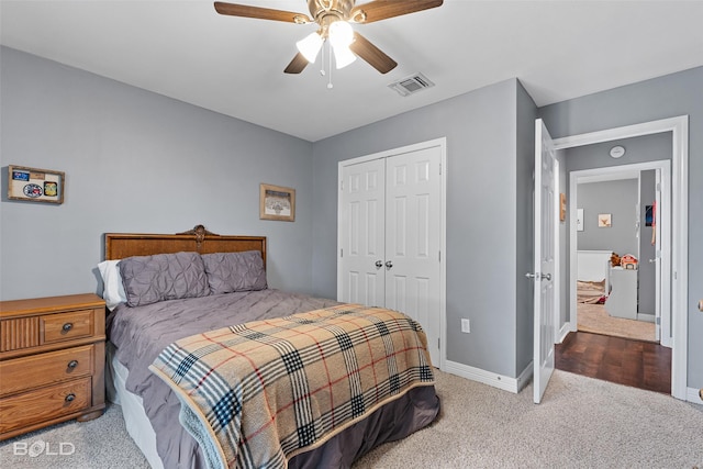 carpeted bedroom with ceiling fan and a closet