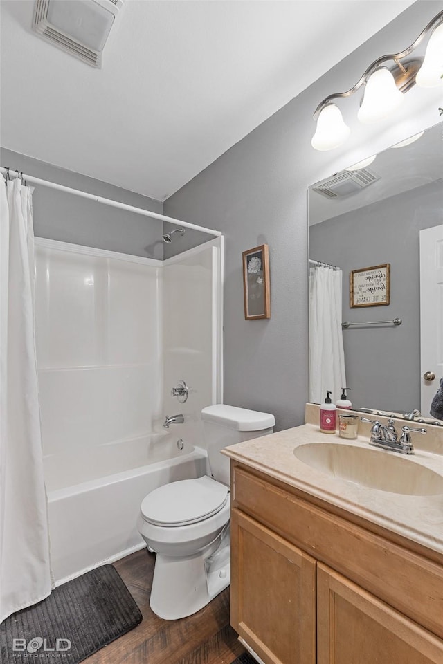 full bathroom with hardwood / wood-style flooring, vanity, toilet, and shower / tub combo with curtain