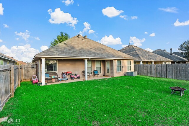 back of house with a patio, central AC, and a lawn