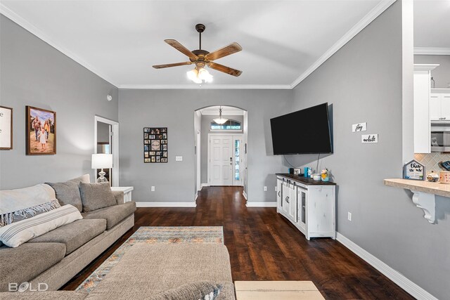 living room with ceiling fan, dark hardwood / wood-style flooring, and crown molding