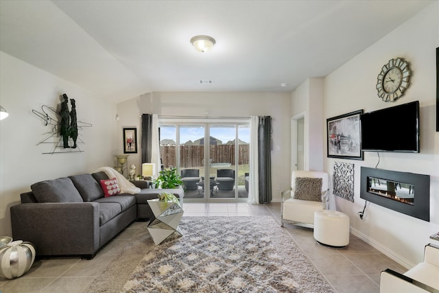 living room featuring light tile patterned flooring and lofted ceiling