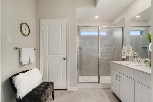 bathroom featuring vanity, a shower with shower door, and tile patterned floors