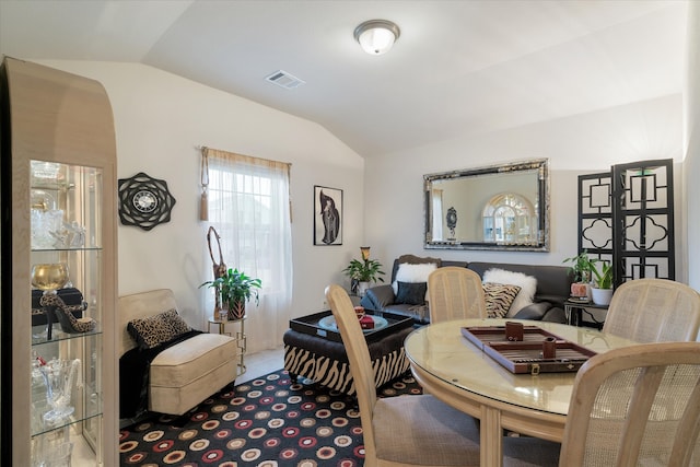 sitting room featuring vaulted ceiling