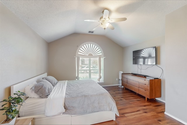 bedroom featuring a textured ceiling, ceiling fan, dark wood-type flooring, and lofted ceiling