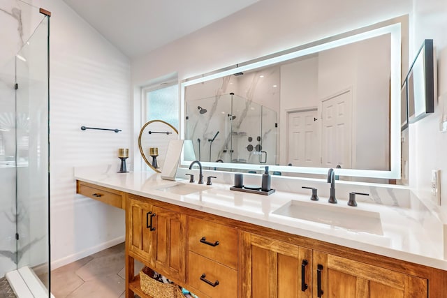 bathroom featuring tile patterned floors, vanity, a shower with shower door, and lofted ceiling