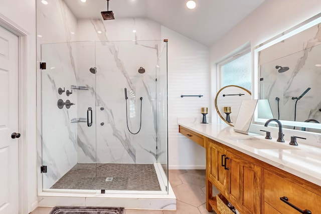 bathroom with vanity, lofted ceiling, tile patterned floors, and a shower with door