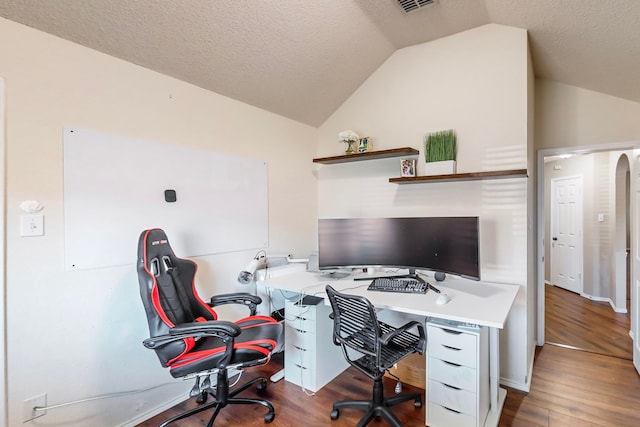 office with a textured ceiling, lofted ceiling, and dark hardwood / wood-style floors