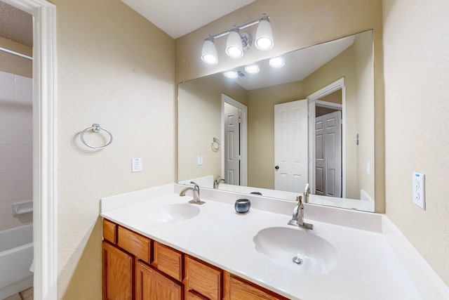 bathroom featuring shower / tub combination and vanity