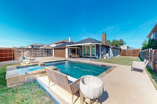 view of swimming pool featuring a lawn, an in ground hot tub, and a patio