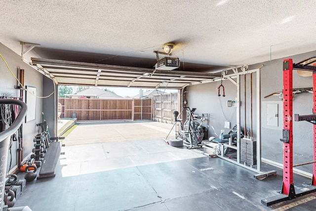 garage with electric panel and a garage door opener