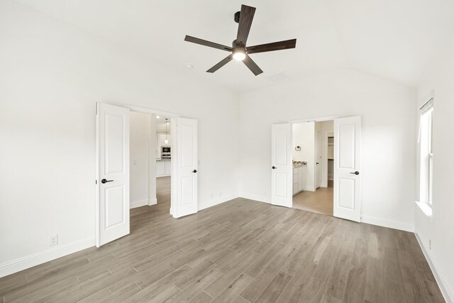 bedroom with ceiling fan, light colored carpet, and lofted ceiling