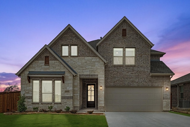 view of front of property with cooling unit, a garage, and a lawn