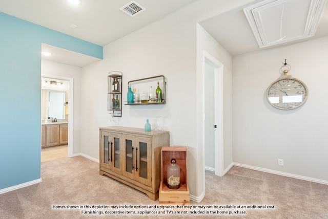 hall with sink and light carpet