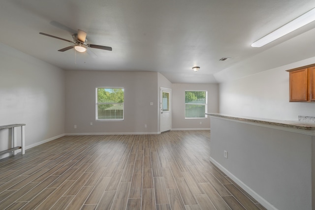 unfurnished living room featuring hardwood / wood-style floors and a wealth of natural light