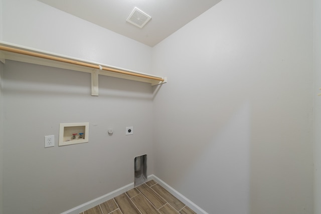 laundry room featuring hookup for an electric dryer, hookup for a gas dryer, light wood-type flooring, and washer hookup