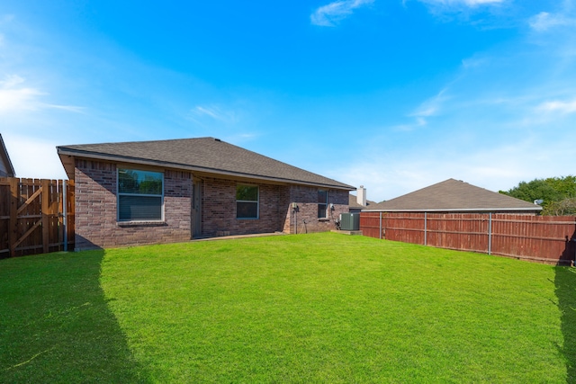 rear view of property with a lawn