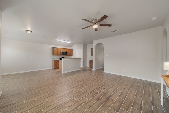 unfurnished living room with light hardwood / wood-style flooring and ceiling fan