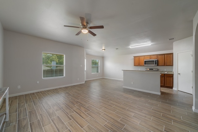 unfurnished living room with ceiling fan and light hardwood / wood-style floors