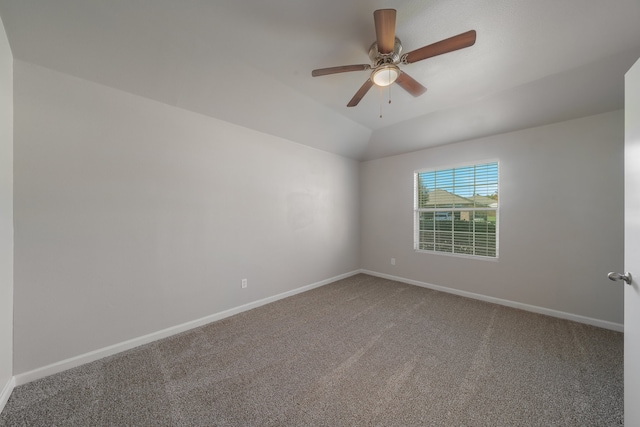 carpeted spare room with ceiling fan and lofted ceiling