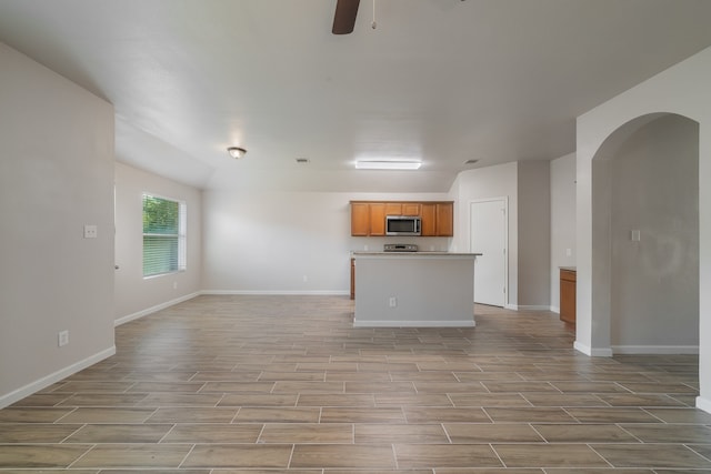 unfurnished living room with ceiling fan and light hardwood / wood-style flooring