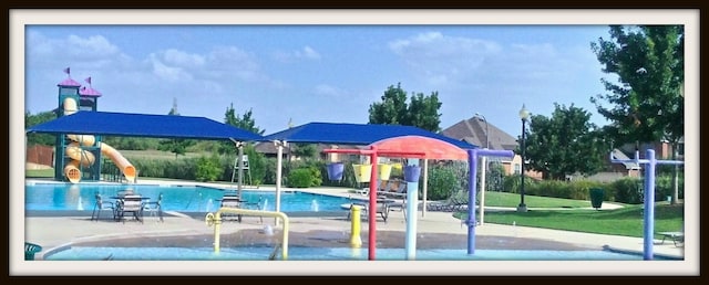 view of swimming pool with a water slide