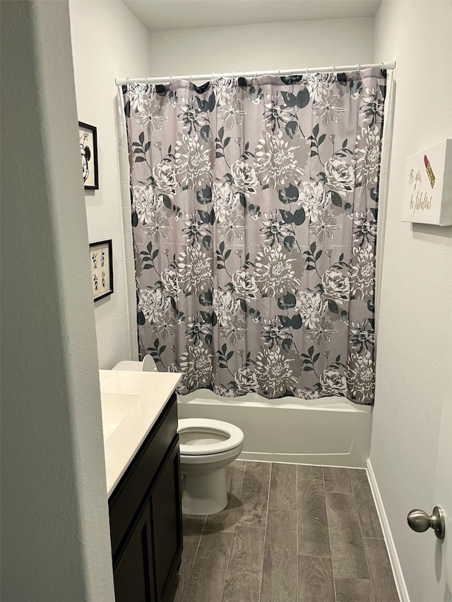 full bathroom featuring shower / bath combo, vanity, and toilet