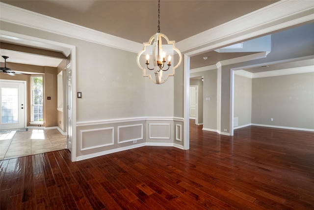 unfurnished dining area with ceiling fan with notable chandelier, dark hardwood / wood-style flooring, and ornamental molding