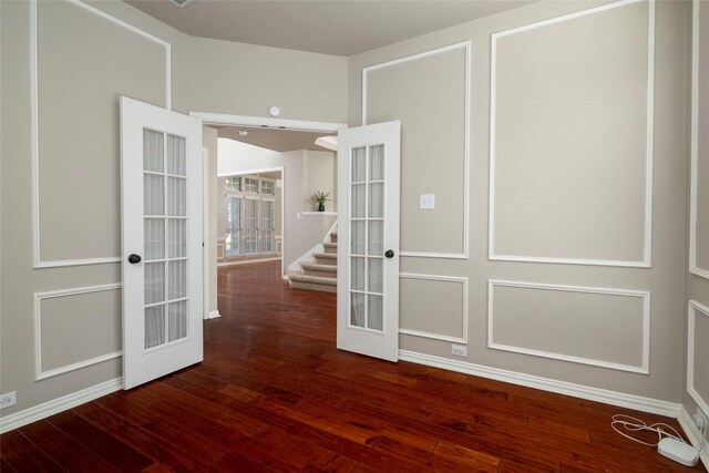 unfurnished room with dark hardwood / wood-style flooring and french doors