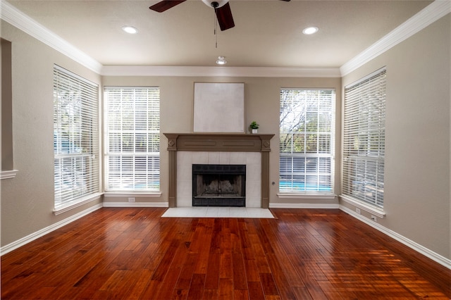 unfurnished living room featuring ceiling fan, wood-type flooring, and plenty of natural light