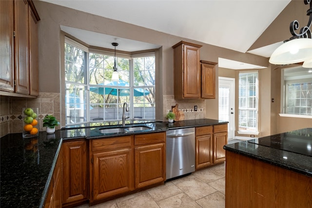 kitchen with plenty of natural light, sink, stainless steel dishwasher, and pendant lighting