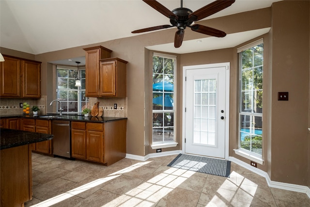 kitchen with decorative backsplash, stainless steel dishwasher, and a wealth of natural light