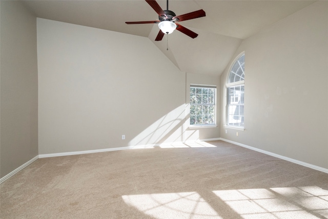 spare room featuring ceiling fan, lofted ceiling, and carpet flooring